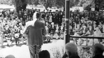 A crowd of people watch Minister for Works and Local Government, Mr Spooner announce Orange's 150th anniversary celebrations. Picture courtesy of NSW State Library.