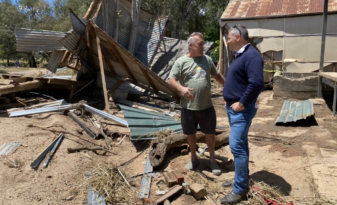 Eugowra resident Mark Wykamp speaks with member for Orange Phil Donato about the devastation caused by the flood.