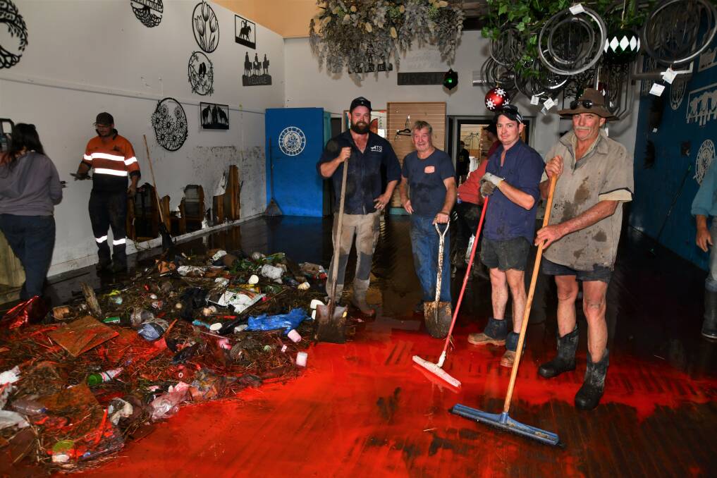 Sam Weeks, Jack Mann, Rob Ferguson and Les Roberts help clean up Eden Decor and Gifts in Molong. Pictures by Carla Freedman
