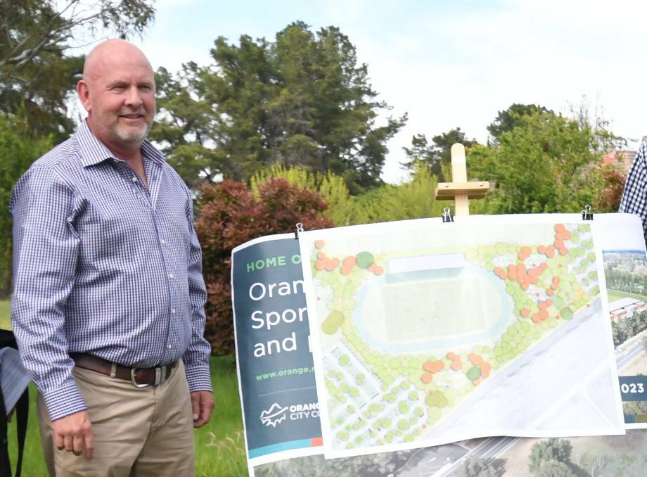 Orange City Council mayor Jason Hamling in front of the initial plans for the sports stadium. Picture by Jude Keogh