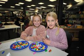 Ellie Willis and Merryn Springer back in the July 2021 winter school holidays at the Lego workshop together in Orange. Picture by Jude Keogh