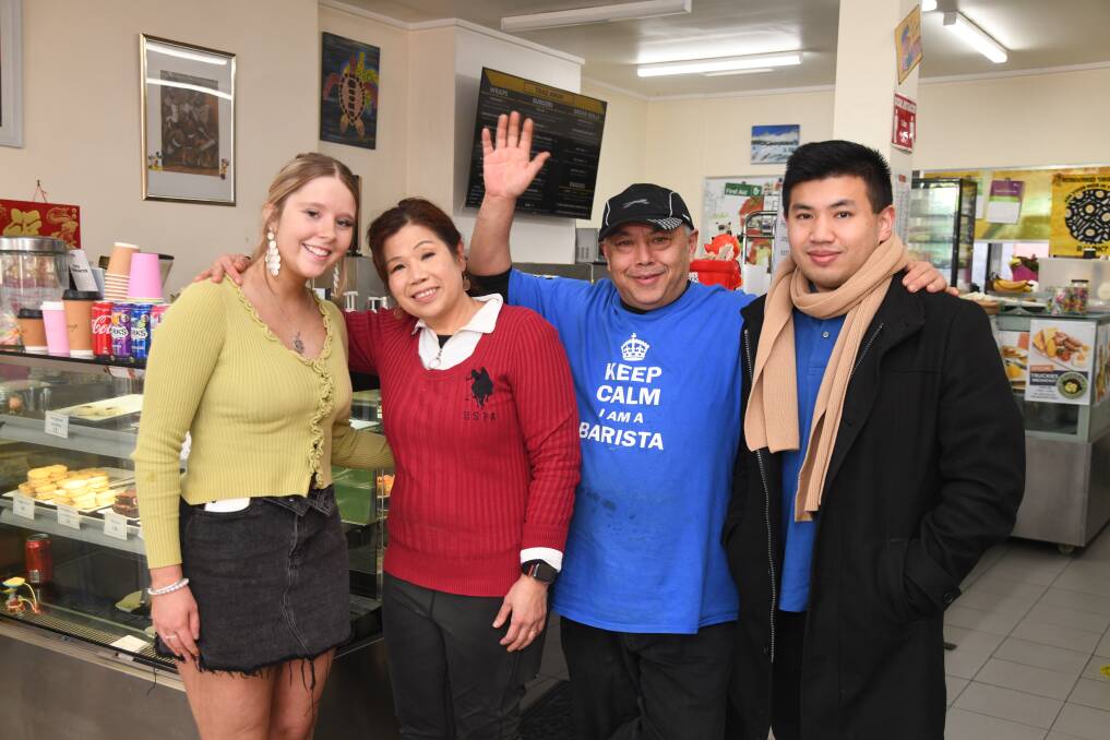 Staff member Chloe Smith with Sopee, Rodney and Seb Soo at the Cheeky Barista cafe in Orange. Picture by Jude Keogh