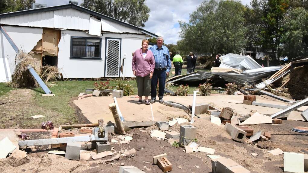 Eugowra's Dorothy and Robert Jones stand in the rubble of what's left of their deluged home with Cabonne Council 'committed' to fast-tracking buy-back scheme. Picture by Carla Freedman.