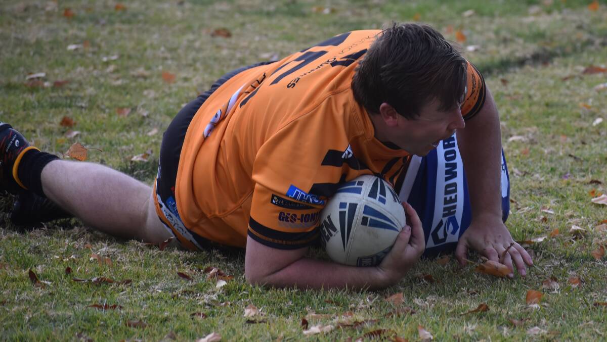 That Molong player couldn't stop Alan Callaghan getting over the line for a late try. Photo Peter Bowditch