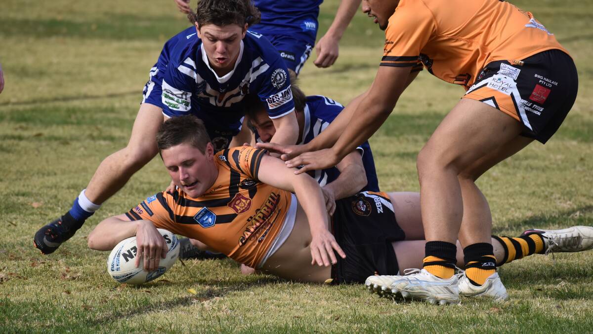 The Bulls defence tried but it's another four points to the Tigers. Photo Peter Bowditch