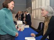 Sarah Klenbort has her copy of The Olive Sisters signed by author Amanda Hampson at a previous Orange Readers and Writers Festival. Picture is from file