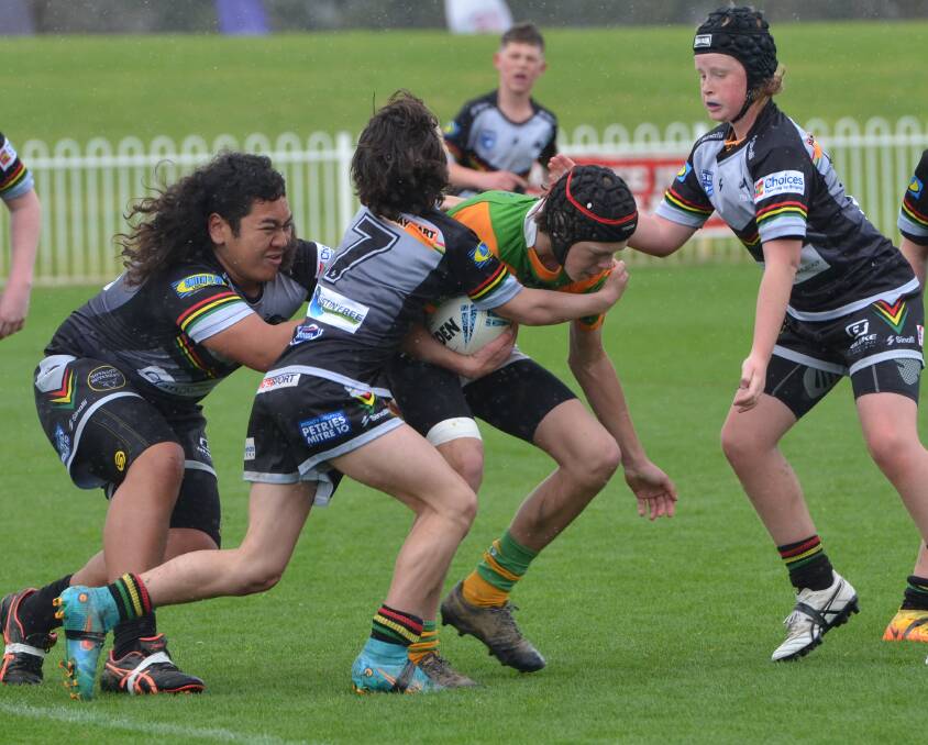Bathurst Panthers players work to stop an Orange CYMS rival in this year's Group 10 Junior Rugby League under 13s grand final. A revamp of junior league means players won't contest competitive games until they are in the 13s age group. Picture by Anya Whitelaw