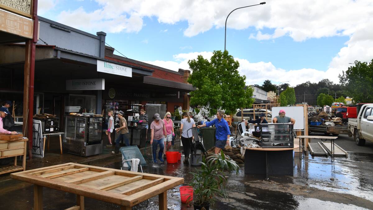The Molong community rallies to clean up Bank Street following the flooding on November 14. Picture by Carla Freedman