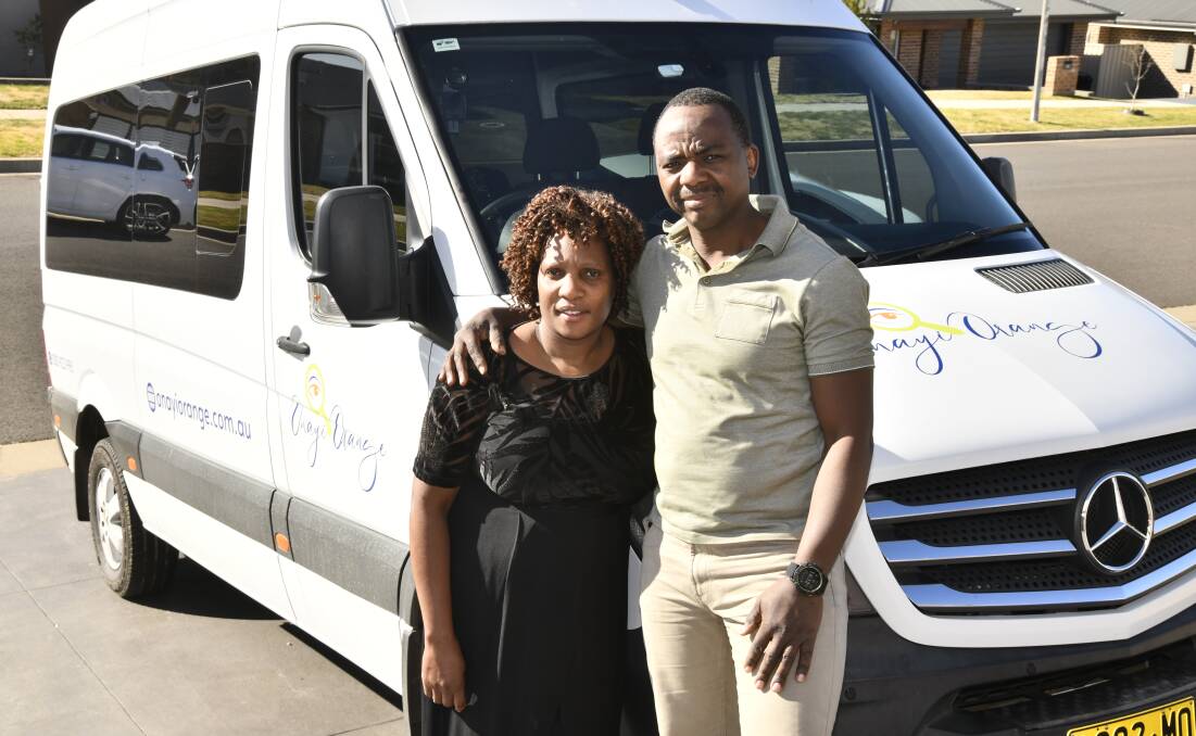 Nyari and John Rukundu with one of their vehicles they are using for Onayi Orange bus charters. Picture by Jude Keogh