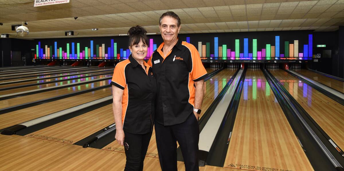 Marissa and Aldo Belmonte with the new media wall that takes up all 16 lanes at Orange Tenpin Bowl. Picture by Jude Keogh