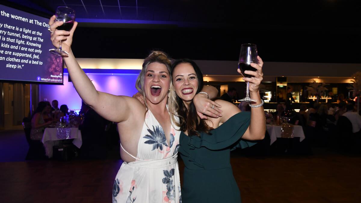 Genevieve Goodwin and Stephanie Cook helped Housing Plus raise money for The Orchard at White Tie Ball on Saturday night. Picture by Carla Freedman. 