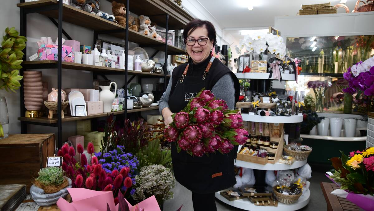 Pick Me Flowers and Gifts owner and award finalist Jane Hyde inside her Sale Street shop with a bunch of proteas from Hills of Fire Flora at Manildra. Picture by Carla Freedman