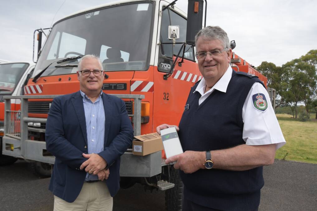 RECEPTION: General manager for Telstra Northern NSW Mike Marom and (with new booster) superintendent David Hoadley, Canobolas RFS zone manager. Photo: JUDE KEOGH.