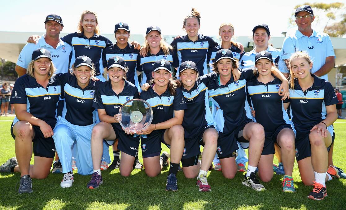WE ARE THE CHAMPIONS: McKenzie Carr (far right, front) and her ACT-NSW Country side celebrates its Australian title victory. Photo: CRICKET AUSTRALIA