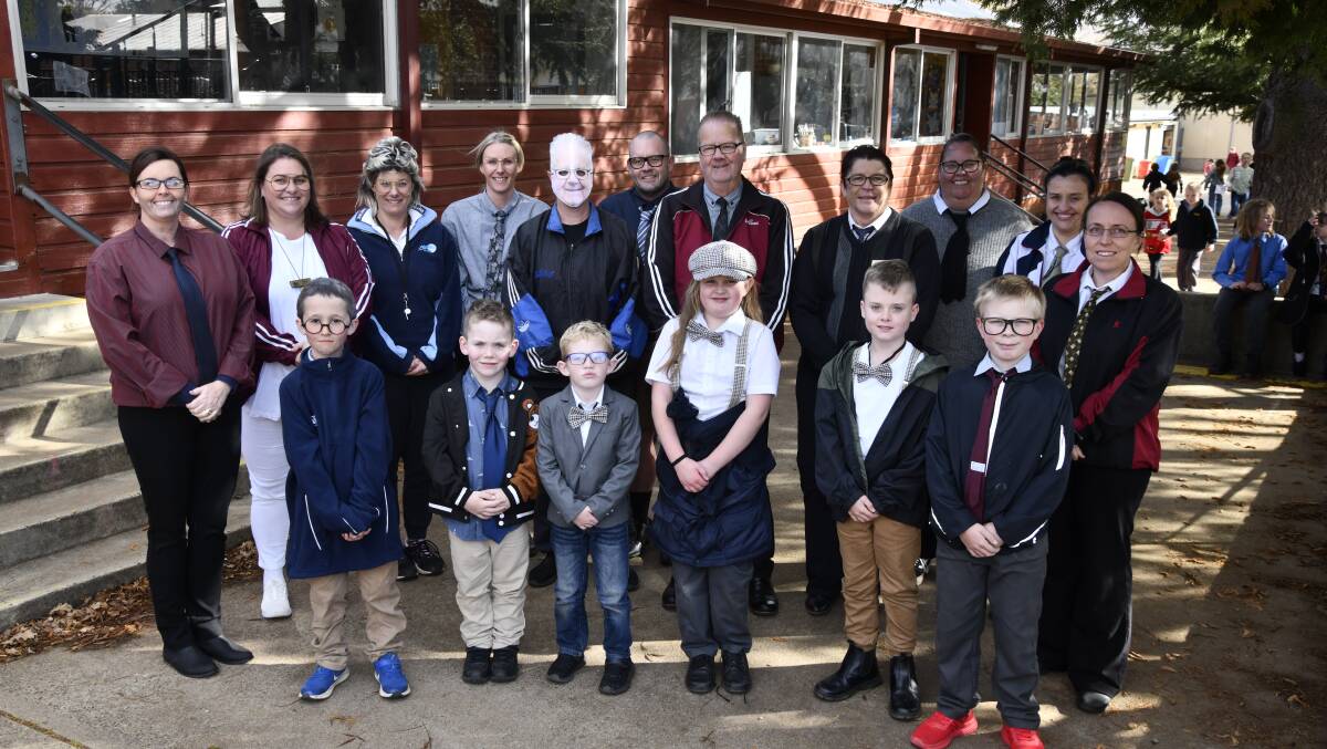 Retiring teacher Peter Cook surrounded by students and colleagues at Orange East Public School on 'Mr Cook Day'. Picture by Jude Keogh 