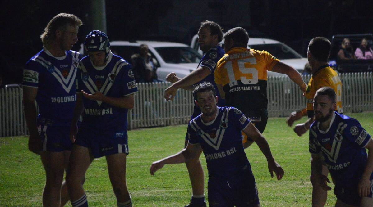 Hayden Robinson (15) takes aim at the crowd, kicking the ball into the fence in front of the Molong section after going over for a try. Picture by Riley Krause.