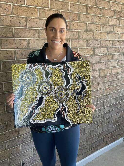 Casey Naden with her artwork for which the guernseys are based on. Picture supplied