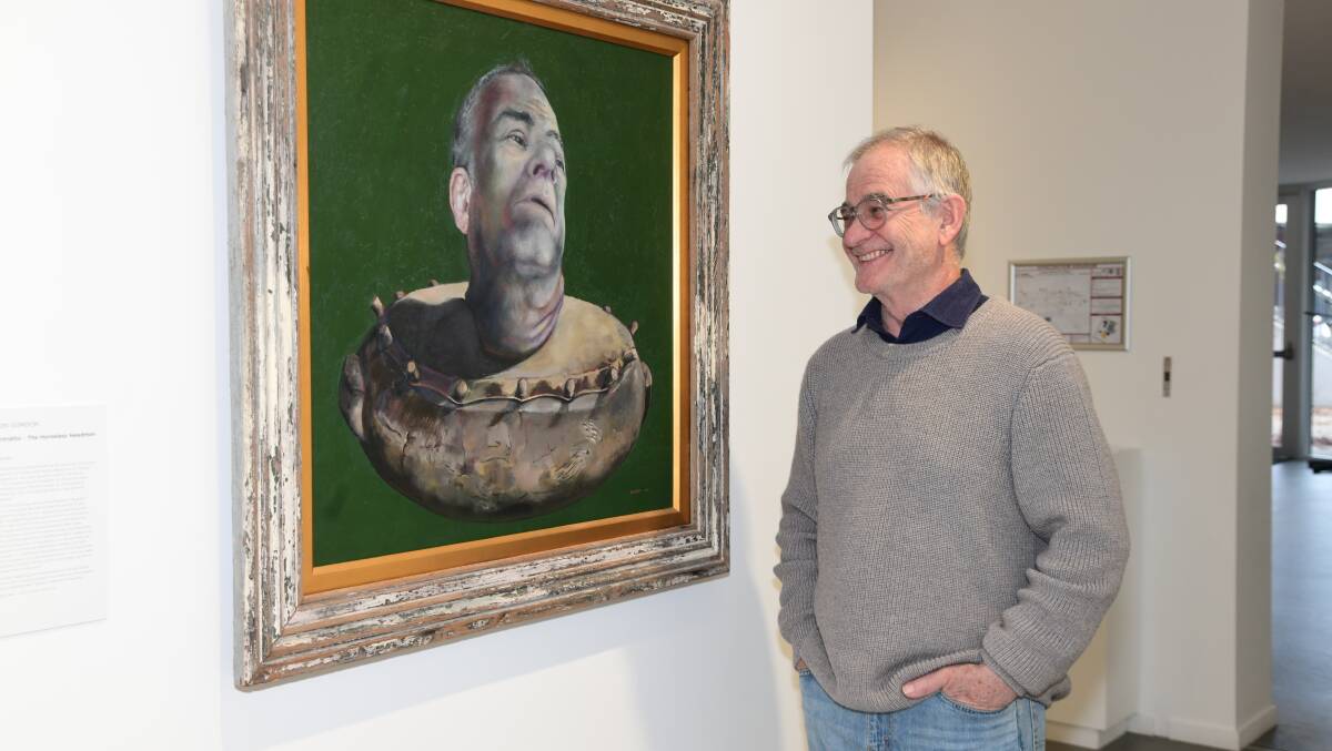 Victor Gordon with one of his art pieces which is on show at the Orange Regional Gallery. Picture by Carla Freedman