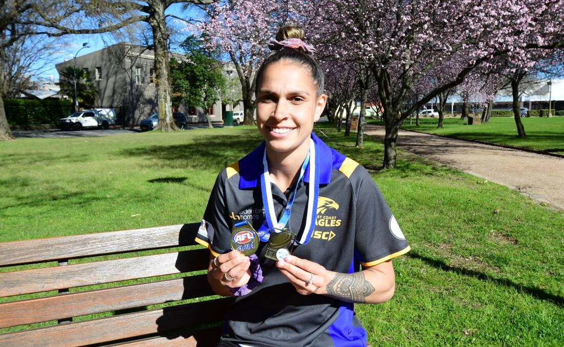 Erin Naden showing off her her premiership medals she won on back-to-back days. Picture by Carla Freedman.