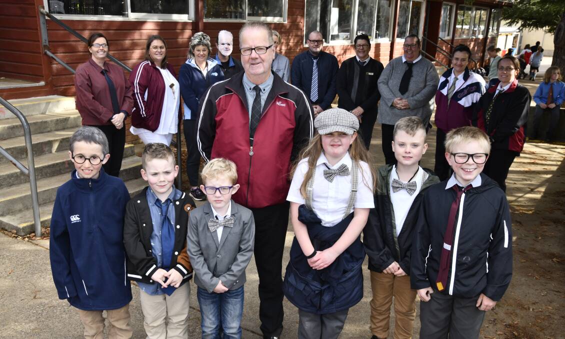 Retiring teacher Peter Cook - front and centre - surrounded by students and colleagues at Orange East Public School on 'Mr Cook Day'. Picture by Jude Keogh 
