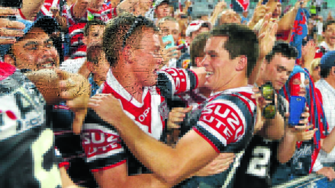 Daniel Mortimer celebrates with Sydney Roosters fans after the 2013 grand final. It wasn't until last year that he realised the man he's embracing was Cowra's Jack Nobes. Picture from file 