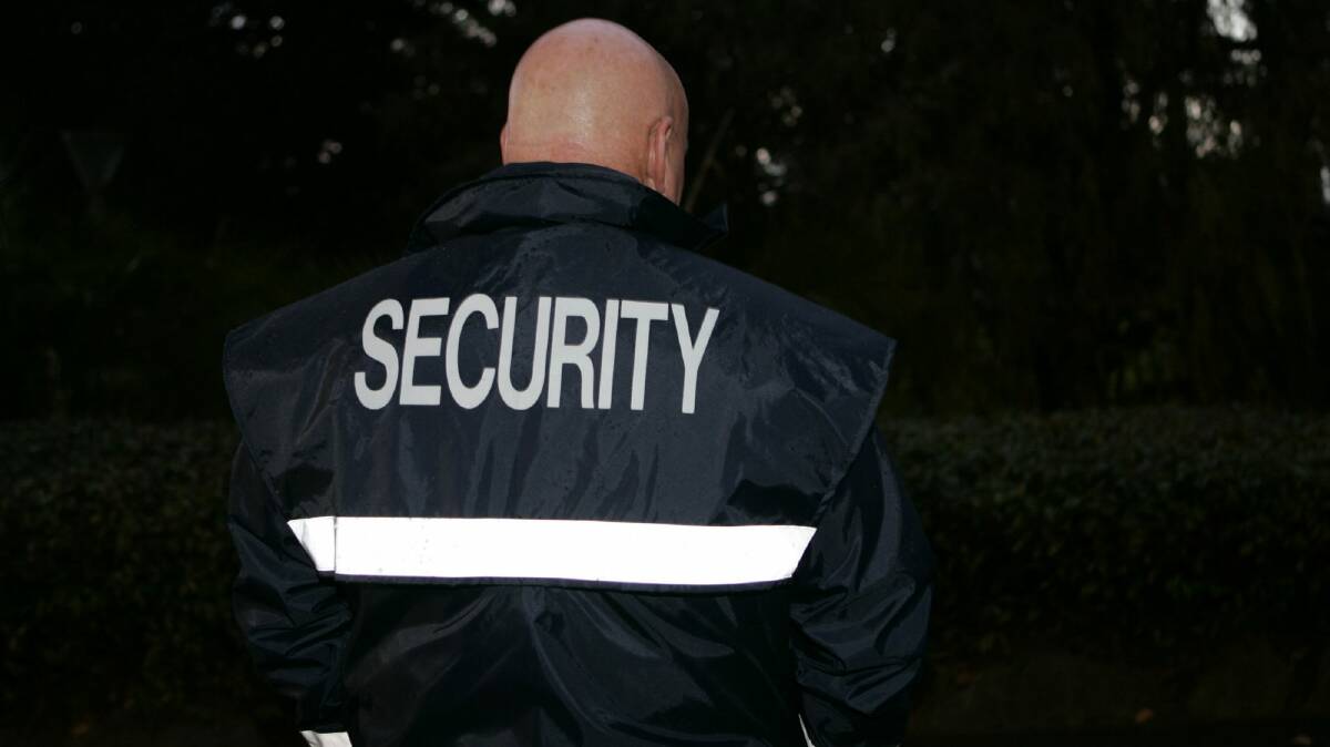 A generic photo of an unidentifiable man in a security vest. Picture is from file