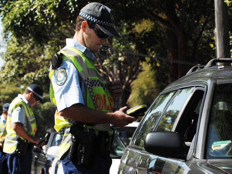 A photo of a NSW Police officer doing a random breath test. This picture is from file