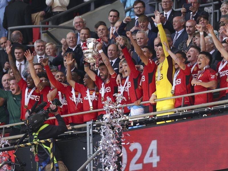 Manchester United celebrate as captain Bruno Fernandes lifts the FA Cup after the win over Man City. (AP PHOTO)