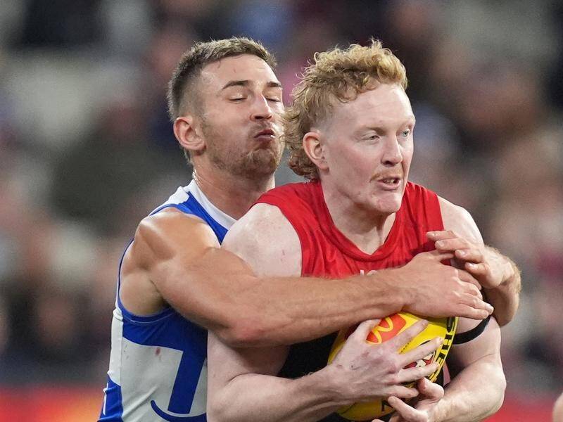 Kangaroos' Will Phillips got close up and personal in his duel with Demons' Clayton Oliver. (Daniel Pockett/AAP PHOTOS)