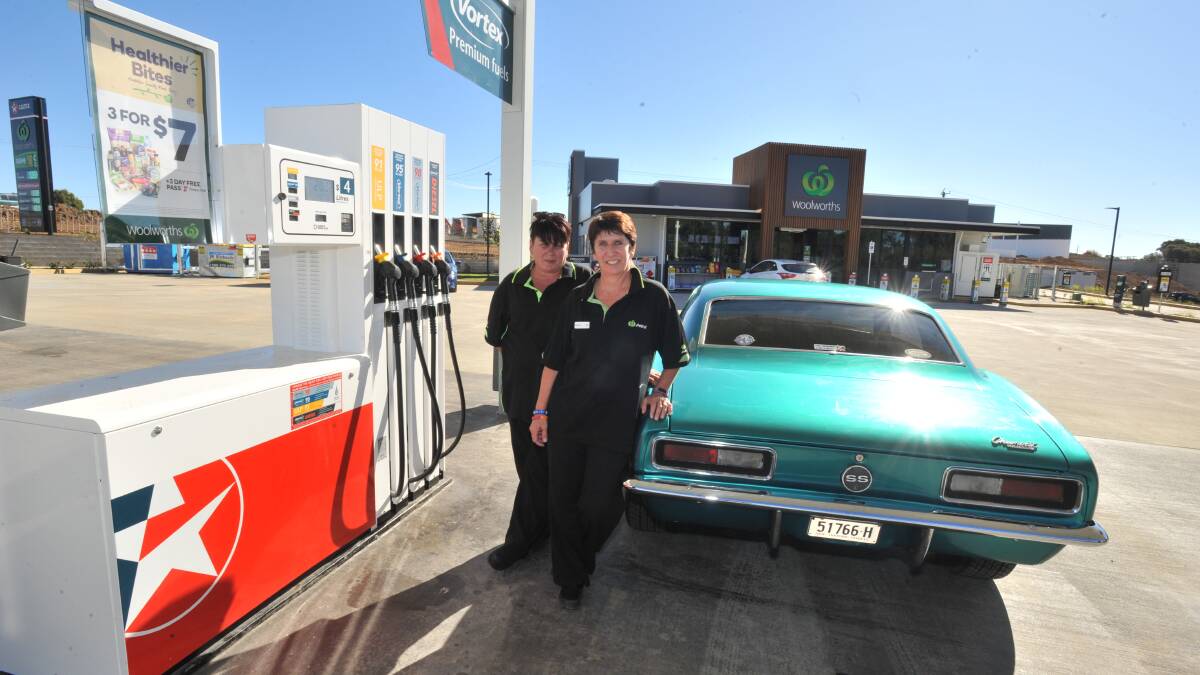 OPEN FOR BUSINESS: Woolworths Petrol North Orange manager Simone Sutherland and assistant manager Belinda Ellis at the newly opened station on the corner of the Northern Distributor Road and Leeds Parade which opened at the weekend. Photo: JUDE KEOGH 0425wooliespetrol
