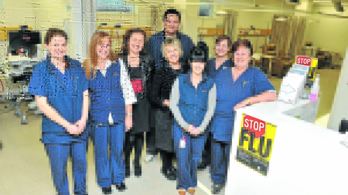 TEAM EFFORT: Staff of Orange’s ambulatory care unit Julie Cave, nursing unit manager Kim Hansen, Di Tove Riphagen, Kerrie Reid, Sharna Morton, Maureen Templar and (back) Josh Williams and Lizzie James along with their colleagues at Orange Health Service have contributed to the service coming in under budget. Photo: JUDE KEOGH 
