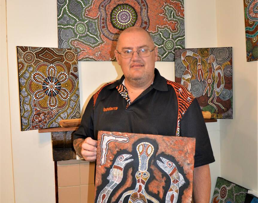 Contemporary Wiradjuri artist Rick Slaven with some of the artworks he has created. Picture by Alanna Tomazin