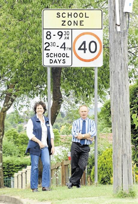 BACK TOMORROW: Kinross Wolaroi’s Vanessa Hannan  and Paul Tierney are reminding motorists to slow down in school zones. Photo: MARK LOGAN 0124mlspeedzone