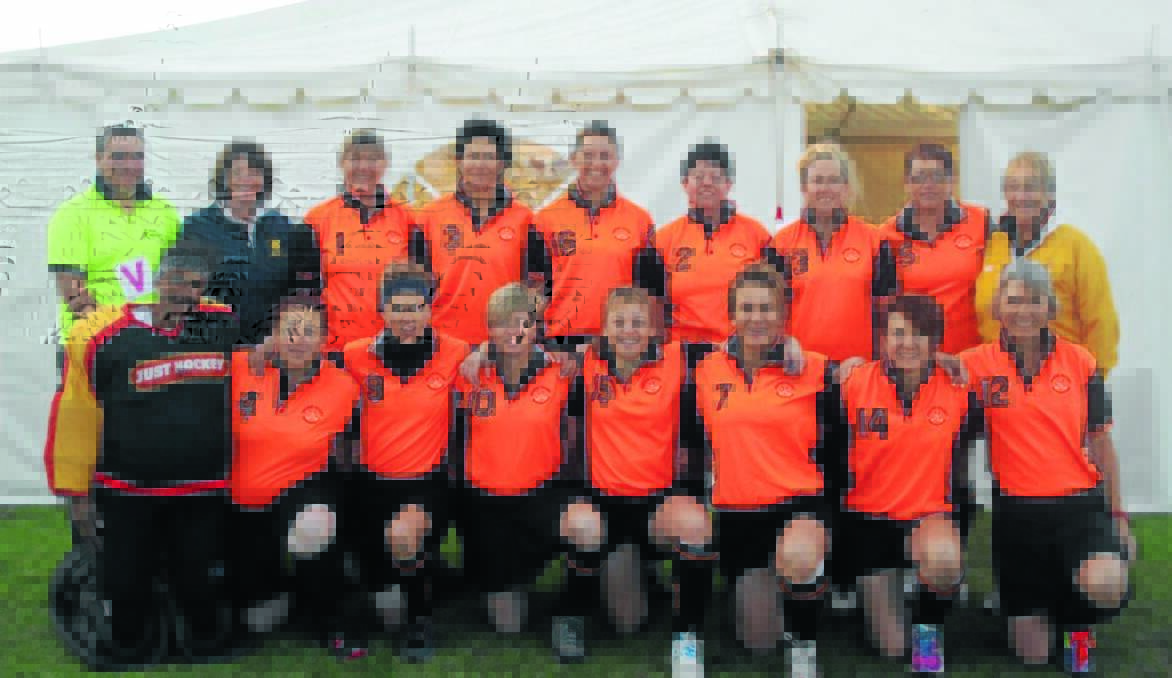WINNERS ARE GRINNERS: The Orange over 40s side took out the NSW south half state championship (back left) Andy Stevenson (umpire), Trudy Warburton (manager), Tracey Cooper, Louise Barrett, Renee Burrell, Joanne Iffland, Mary-Ellen Betts, Karen McPaul, Lorraine Corby (coach), (front, left) Gail Fuller (goalie), Samone Vennard, Mia Scolari, Alison Smith, Tanya Standing, Cathy Goodlock, Janelle Henderson, Kate Brown.                                                     Photo: AMARLIE DENT